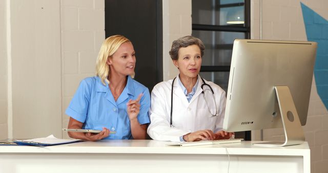 Doctors Discussing Medical Records on Computer in Hospital Office - Download Free Stock Images Pikwizard.com