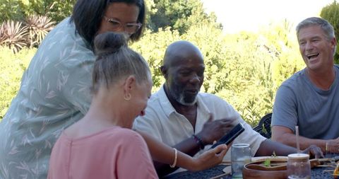 Group of Friends Enjoying Outdoor Gathering with Smartphone