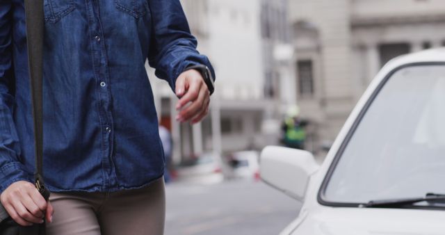 Person in Denim Shirt Walking Near White Car in Urban Area - Download Free Stock Images Pikwizard.com