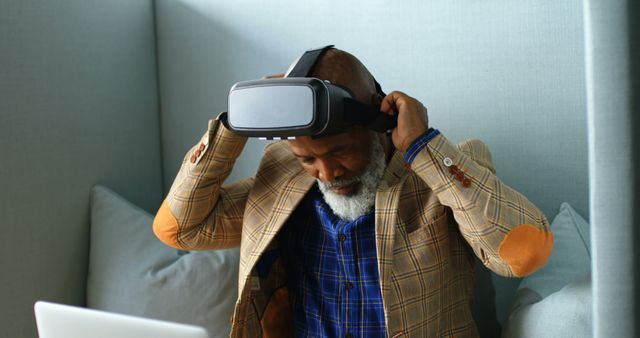 Elderly man trying virtual reality headset in modern office - Download Free Stock Images Pikwizard.com
