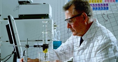 Seasoned chemist adjusting clamped burette on lab bench wearing safety glasses, lab coat