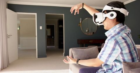 Teen Using VR Headset in Living Room for Immersive Experience