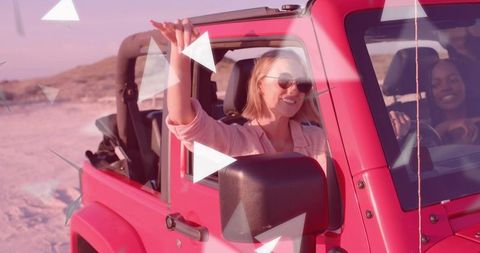 Friends Enjoying Sunset Drive in Vibrant Pink Jeep
