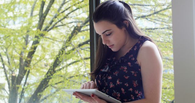 Young Woman Using Tablet by Large Window with Nature View - Download Free Stock Images Pikwizard.com