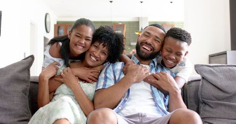 Happy Family Laughing Together on Cozy Living Room Sofa - Download Free Stock Images Pikwizard.com
