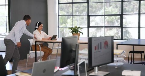 Multiracial Colleagues Collaborate in Modern Office Environment
