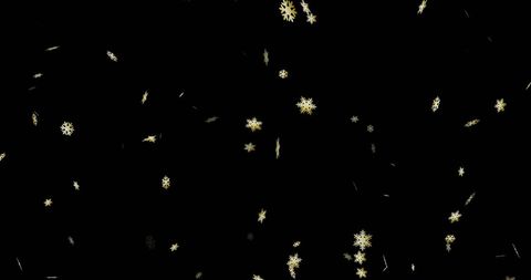 Golden snowflakes falling on black background celebratory scene