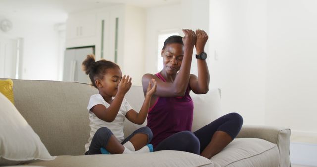 Mother and Daughter Practicing Yoga on Couch at Home - Download Free Stock Images Pikwizard.com