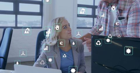 Colleagues working with eco technology interface in office