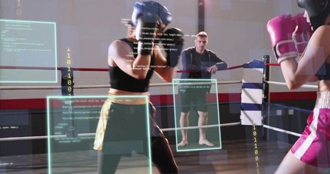 Female Boxers Sparring with Augmented Reality Overlays Coach Monitoring Performance Data