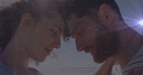 Romantic beach moment with sunlit overlay