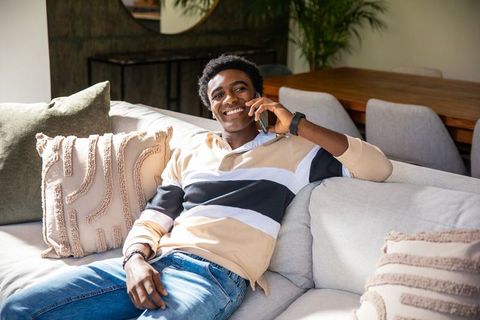 Relaxed Man Enjoying Leisure Time at Home on Cozy Sofa