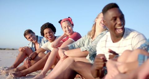 Joyful Friends Having Fun and Laughing at Sunny Beach