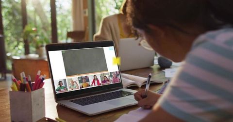 Child Studying at Home Attending Virtual Classroom While Parent Working Remotely