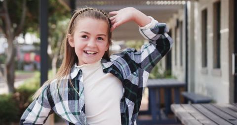 Playful Girl Posing Outdoors in School Courtyard