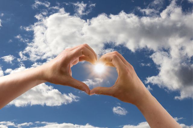Hands Forming Heart Shape with Blue Sky and Clouds - Download Free Stock Photos Pikwizard.com