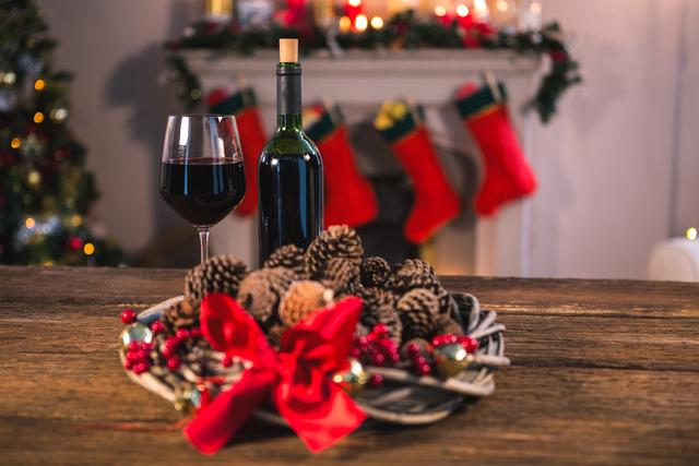 Festive Holiday Table with Red Wine and Pine Cones - Download Free Stock Photos Pikwizard.com