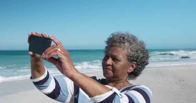 Happy Senior Woman Taking a Selfie on the Beach - Download Free Stock Images Pikwizard.com