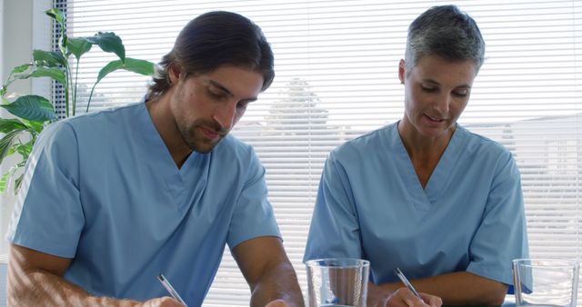 Healthcare Professionals Taking Notes in Hospital Setting - Download Free Stock Images Pikwizard.com