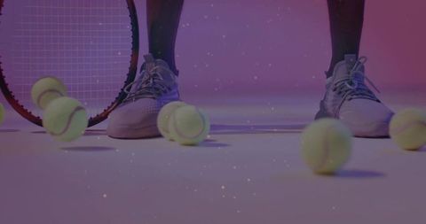 Tennis player's footwork with balls and racket in studio