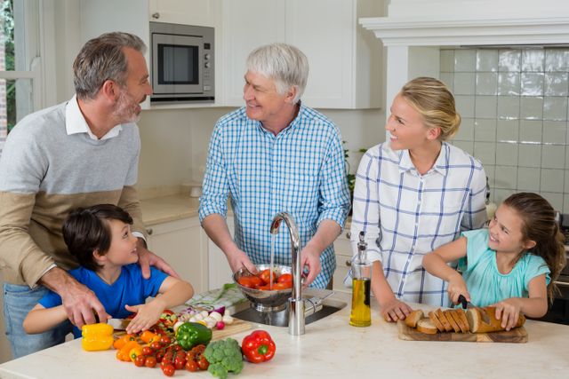 Senior man interacting with his family while preparing food in kitchen