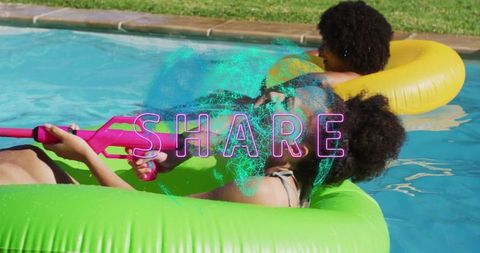 Women Enjoying Summer Pool Fun with Water Guns