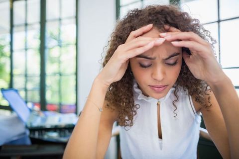 Woman overcoming stress in bright café environment
