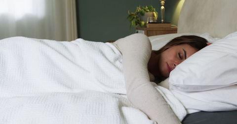 Peaceful Resting Woman Relaxing Comfortably in Cozy Bedroom
