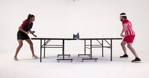 Competitive table tennis match in bright studio
