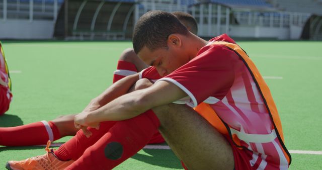 Dejected Young Soccer Player Sitting on Field Head Down - Download Free Stock Images Pikwizard.com