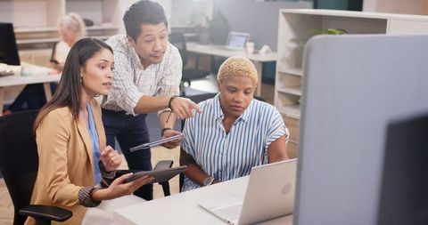 Diverse Team Collaborating on Project Using Technology