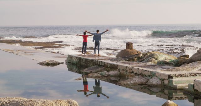 Young Friends Enjoying Scenic Ocean View on Coastal Walkway - Download Free Stock Images Pikwizard.com