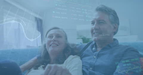 Senior Couple Relaxing at Home with Stock Market Data Overlay