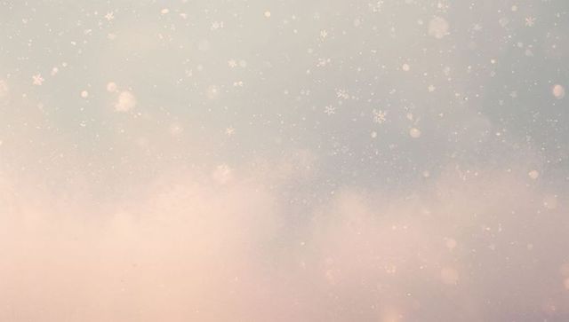Drifting pastel snowflakes with soft bokeh glow and dreamy gradient background