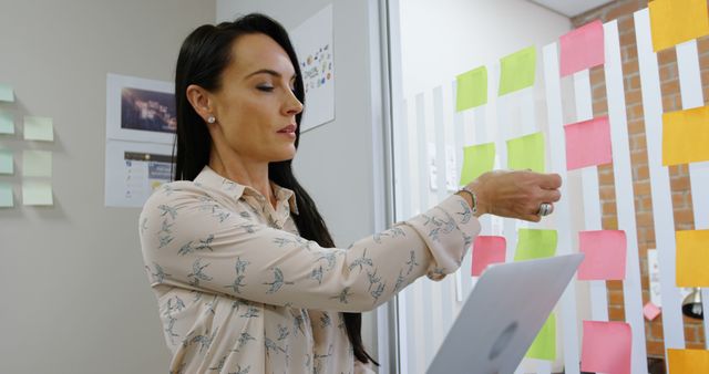 Businesswoman Organizing Sticky Notes in Office - Download Free Stock Images Pikwizard.com