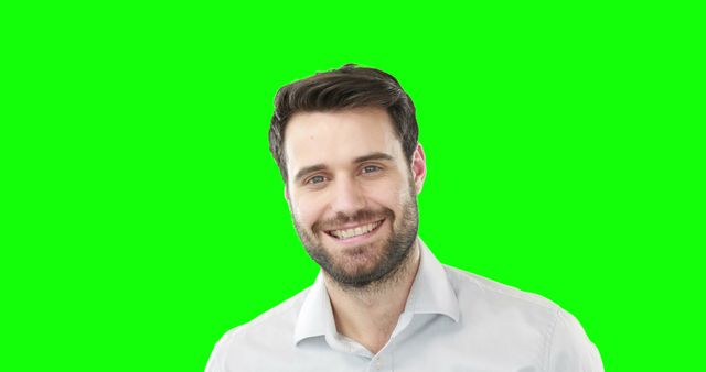 Portrait of smiling man standing against green screen