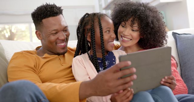 Happy African American Family Using Tablet on Couch - Download Free Stock Images Pikwizard.com