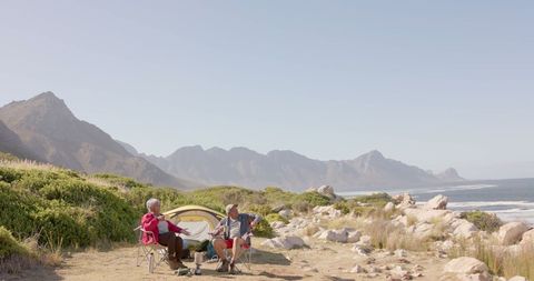 Senior Couple Enjoying Camping by Coastal Mountains