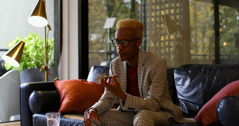 Young Businessman in Plaid Suit Using Smartphone
