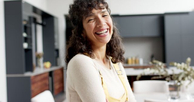 Smiling Woman in Modern Kitchen with Yellow Overalls - Download Free Stock Images Pikwizard.com