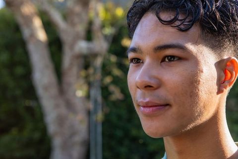 Young Man Reflecting in Sunlit Garden