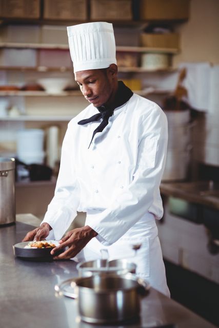 Head chef presenting a salad in commercial kitchen
