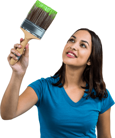 Smiling woman holding a bright green paint brush on transparent background