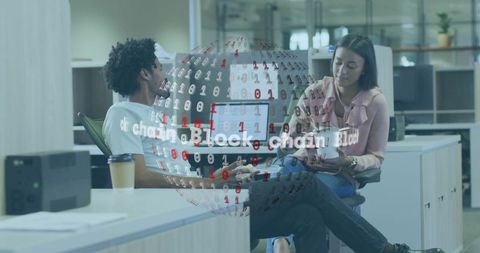 Colleagues discussing blockchain app on tablet in modern open office workspace