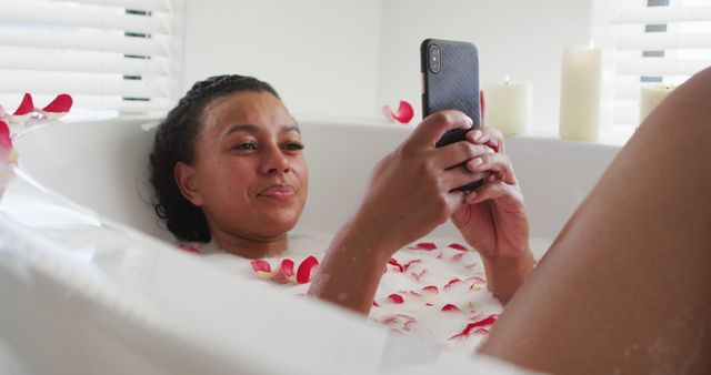 Woman Relaxing in Bathtub with Rose Petals and Smartphone - Download Free Stock Images Pikwizard.com
