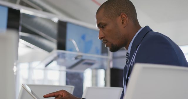 Focused African American Businessman Using Digital Tablet in Modern Office - Download Free Stock Images Pikwizard.com