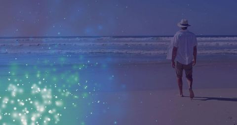 Man walking seaside at dusk with dreamy light overlay