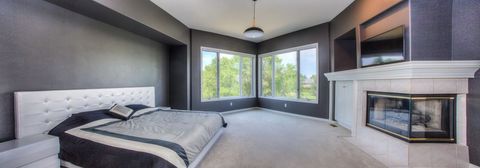 Modern Bedroom with Black Walls and Corner Fireplace