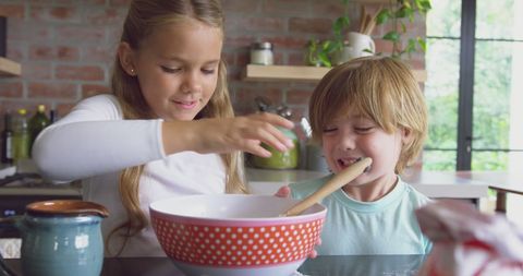 Siblings Baking Together in Bright Domestic Kitchen