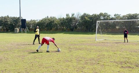 Soccer players preparing for penalty on grass field
